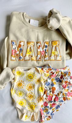 three baby onesuits with the word mamma on them and flowers all over them