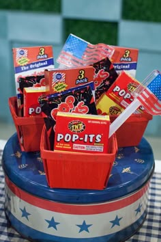 an american patriotic cake with candy in red, white and blue boxes