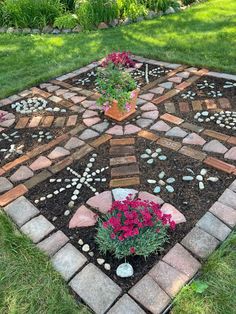 a garden area with flowers and rocks in it