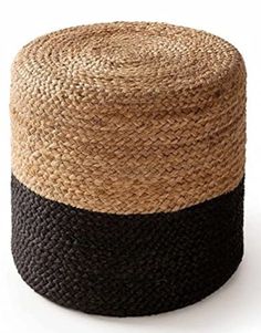 a black and tan basket sitting on top of a white floor