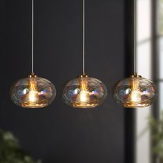 three lights hanging from a ceiling in a room