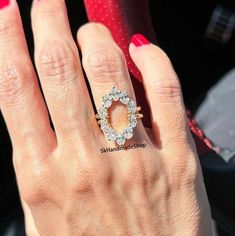 a close up of a person's hand with a diamond ring on their finger