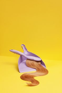 a hairbrush and comb on a yellow background