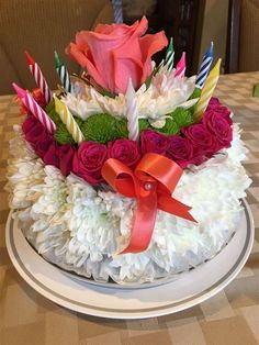 a birthday cake decorated with flowers and candles