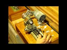 someone is working on an old machine in their home office or craft room with the help of some woodworking tools