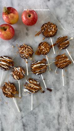 apples and marshmallows on a marble counter with chocolate drizzled over them