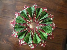 an origami christmas wreath on a wooden table