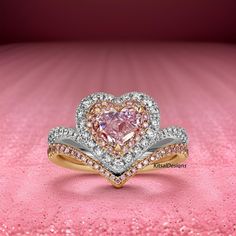 a heart shaped pink diamond ring on top of a pink background with white and yellow diamonds