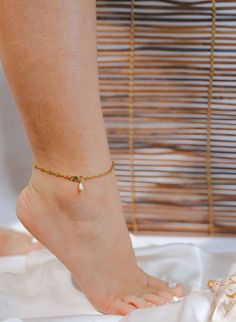 Inspired by the Farsi word for "Gold", the Tala Anklet is a classic, dainty gold chain anklet, handmade with a genuine Freshwater Pearl (each one is unique!). Tala adds a unique touch to any look, and pairs beautifully with other anklets, or on its own as the main character. ANKLET DETAILS: Spiral Gold PVD Stainless Steel Chain Natural Freshwater Pearl Water-Resistant Chain Easy-to-choose sizing: S (9") / M (9.5") / L (10.5") SIZING: Finding a comfortable anklet size is easier than ever. To find your best fit size, measure the length around the bottom of your ankle and add 0.5 inches to that number. For example, if my ankle measures about 9 inches, I would choose the M Size (9.5 inches). *Remember to measure the bottom area around your ankle, as the anklet will naturally fall to that spot. Gold Dangle Anklets With Adjustable Fit, Adjustable Minimalist Pearl Chain Anklet, Adjustable Gold Plated Anklets, Gold Adjustable Dangle Anklets, Gold Delicate Anklet For Gift, Delicate Gold Anklets As Gift, Delicate Gold Anklet For Gift, Metal Anklet With Adjustable Chain As Gift, Adjustable Metal Anklets As Gift