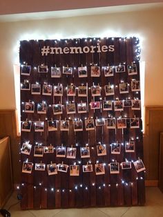 a wooden wall with pictures on it and lights around the edges that spell out memories