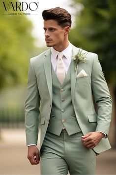 a man in a light green suit and white shirt is walking down the street with his hands in his pockets