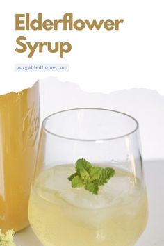 an advertisement for elderflower syrup on a white background with a glass and bottle next to it