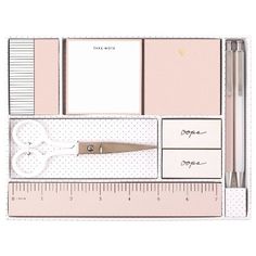 a desk with a ruler, pen and paper on it