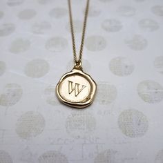 "Monogram Initial letter \"W\" Materials: Silver, Gold, Gold vermeil Gold vermeil is a thick 24k layer of gold over a solid sterling silver base. Size: Approx 3/4\" {20mm} The antique wax seals used to make my initials are mostly around 170 yrs but can be as young as 70 yrs, and as old as 750+ yrs old (My letter i). As each wax seal was individually collected, I am unable to change the font or size. They are only available as shown. PLEASE NOTE: Before you order please check sizing information - it can be hard to gauge jewelry sizes from pictures alone. On some of the seal pieces the text is so small as to be read only with a magnifying glass making the meaning a secret between you and those you choose to tell. Availability and shipping Your purchase will ship in 3-5 business days. Once sh Star Minimalist, Monogram Wax Seal, Wax Seal Pendant, Seal Jewelry, Jewelry Letter, Wax Seal Jewelry, Wax Seal Necklace, Antique Wax, Letter W