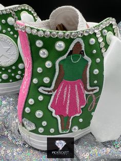 a pair of green and pink shoes with an image of a woman on them