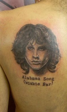 a man with a tattoo on his back that says, obama song wiske bar