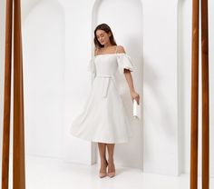 Step into elegance with our stunning Elegant White A-Line Midi Dress! Perfect for any occasion, this  silhouette gracefully highlights your natural waist while the hidden back zipper ensures a seamless look.  **Features - **Color Crisp white  - **Length Midi - **Style A-line, Swing dress  - **Sleeves Short puff sleeves with drop shoulders - **Waistline Natural waist with detachable narrow tie belt - **Fabric Matte fabric (no stretch)    Feel confident at any event--be it a bridal shower, engagement party, or graduation--with this versatile elegant white cocktail dress. The elegant puff sleeves add just the right touch of sophistication to your look. Plus, its plain pattern makes it ideal as a simple wedding dress or cocktail party standout. Imagine twirling in this beautiful white puff sle Cocktail Dress For Wedding Guest, Cocktail Dress For Wedding, Dress For Wedding Guest, Summer Cocktail Party, White Dresses Graduation, Midi Dress Fall, Dress With Puff Sleeves, Dress Sleeves, White Cocktail