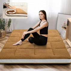 a woman sitting on top of a brown mattress