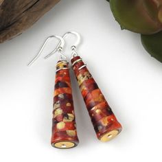 Upcycled paper is hand painted in shades of fiery red, orange, yellow and accented by subtle hints of metallic gold. Once the paint has cured, the paper is cut into longs strips and then carefully rolled into these gorgeous beads. Finally, the beads are glazed with many coats of water-based, non-toxic clear acrylic.   One of a kind and completely unique, this pair of lightweight earring is perfect for any occasion! If giving them as a gift, the earring card tells the process of their creation an Paper Bead Earrings, Paper Bead Jewelry, Earring Card, Creation Crafts, First Anniversary Gifts, Paper Jewelry, First Anniversary, Gold Paper, Earring Cards