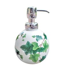 a white glass soap dispenser with green leaves on it