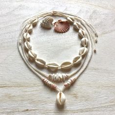 Necklaces are made of natural cowrie shells (16 - 20 mm, single shell 20 - 24 mm), milky white or alabaster rainbow and pearl white original Czech glass beads (2.9 / 4.1 mm Rocailles Preciosa), shell 'puka' beads (5-10 mm) and waxed polyester cord (original Linhasita 1 mm).  They are robust and fully waterproof.  The length is adjustable and should fit all neck sizes (minimum length is 32 cm =12,6 inches and maximum 66 cm = 26 inches).  If you have any questions/wishes, please don't hesitate to Cheap Shell Beaded Necklaces With Round Beads, Cheap Bohemian Shell Beaded Necklaces, White Shell Jewelry With Ocean-inspired Style, Adjustable Cream Shell Necklace For Beach, Cream Shell Necklace For Beach, White Cowrie Shell Jewelry, Cream Shell-shaped Shell Jewelry, Adjustable White Cowrie Shell Necklace, Adjustable Natural Color Shell-shaped Necklace