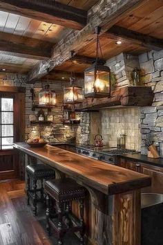 Cozy rustic kitchen bar with a solid wood countertop, stone walls, and lantern-style pendant lights, creating a warm and inviting atmosphere. Wood Grain Tile Kitchen, Cabin Countertop Ideas, Rustic Kitchen Ideas On A Budget, Rustic Bar Design, Log Cabin Bar, Kitchen Altar, Log Cabin Kitchen Ideas, Cozy Cabin Kitchen