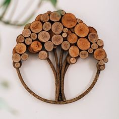 a tree made out of wood sitting on top of a white wall