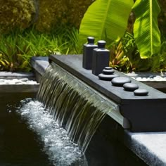 an outdoor fountain with water flowing from it