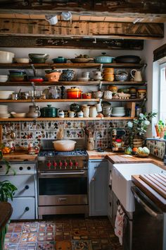 a kitchen filled with lots of pots and pans on top of wooden shelves next to a window