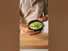 a man holding a bowl of food in his hands