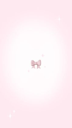 two pink bows are hanging from the side of a light pink wall with stars in the background