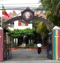 a man standing in front of a colorful gate