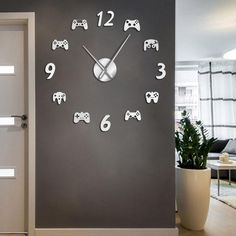 a wall clock with video game remotes on it in a room next to a door