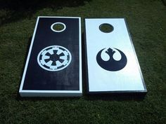 two star wars themed cornhole tossers on the grass in front of each other