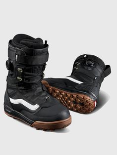 a pair of black snow boots with brown soles