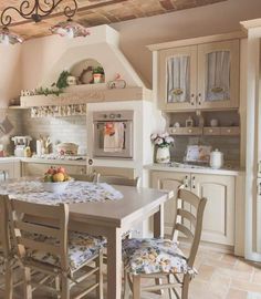 a kitchen with an oven, table and chairs