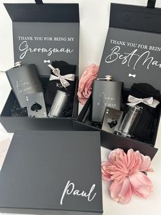 three personalized flasks in black boxes with pink flowers on the side and thank you for being my groomsman