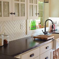 a large kitchen with white cabinets and black counter tops is pictured in this image from the front view