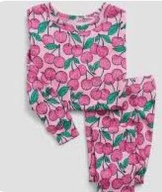 This adorable baby pajama set from Gap features a playful cherry theme and is made from 100% organic cotton. The set includes a long-sleeved top and pants, both in a pretty pink color. It is sized for babies 12-18 months and comes with tags attached. The pajama set is perfect for keeping your little one cozy and comfortable during sleep time. It is a great addition to any baby's wardrobe and makes a lovely gift for new parents. Sweet Cotton Long Sleeve Sets, Sweet Long Sleeve Cotton Sets, Pink Cotton Sleepwear For Spring, Pink Cotton Sets With Strawberry Print, Pink Cotton Sleepwear For Fall, Cute Pink Strawberry Print Sets, Playful Pink Cotton Sleepwear, Sweet Long Sleeve Pink Sets, Sweet Pink Long Sleeve Sets