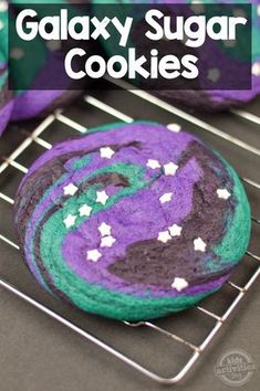 a close up of a cookie on a rack with the words galaxy sugar cookies above it