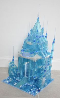 a blue building made out of ice and snow flakes on top of the floor