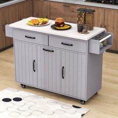 a kitchen island cart with food on it in the middle of a flooring area