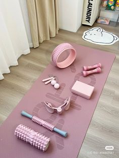 a pink yoga mat with various items on it