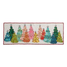 a white rug with colorful christmas trees on it