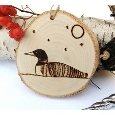 a wooden ornament with an image of a bird on it