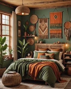 a bedroom decorated in green and orange with pictures on the wall above the bed, potted plants next to the bed