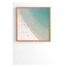 an aerial view of a beach with people walking on the sand and in the water