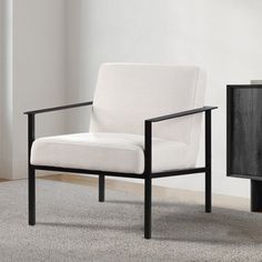 a white chair sitting next to a black cabinet on top of a carpeted floor