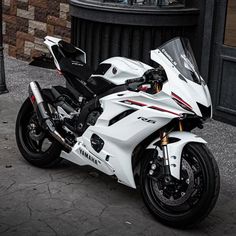 a white and black motorcycle parked on the street