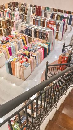 the interior of a book store with many books and bags on display in front of them